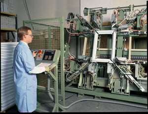 Man in window factory welding impact glass window frame