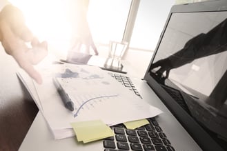 Close up of business man hand working on laptop computer with social media diagram and chart graph on wooden desk as concept