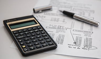 Calculator and budget document on desk