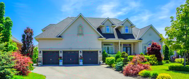 House in spring time with lush greenery surrounding it