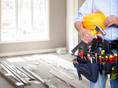 contractor with tools inside a home 