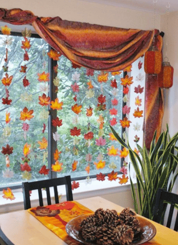 fall leave hanging from the inside of a window