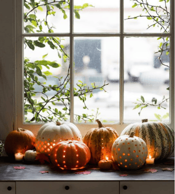 pumpkn lanterns sitting on window sill