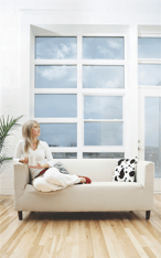 woman sitting on sofa looking out of the window