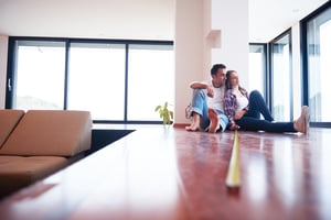 happy young romantic couple at new modern home preparing for hurricane season