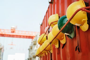 construction helmets lined up on box